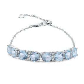 Row of Round Cut Natural Blue Topaz Silver Bracelet